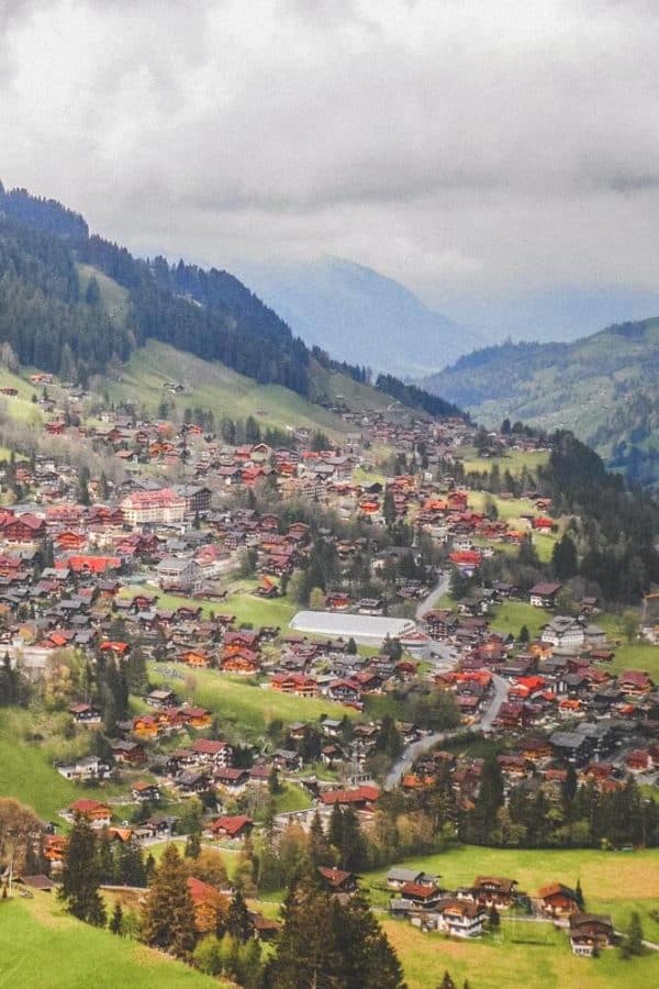 15 prettiest towns in Switzerland! Aerial view of the Swiss town, Adelboden. One of the top things to see in Switzerland! If you are planning a road trip through Switzerland you do not want to miss these small towns! #avenlylanetravel #avenlylane #switzerland #europebucketlist #travel